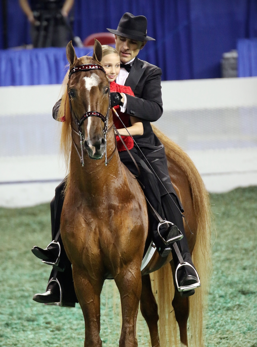 Marc during his retirement ceremony on Friday night of the World's Championship Horse Show, with Lionel and young fan Ella Herrin. Photo by Julia Shelburne-Hitti.