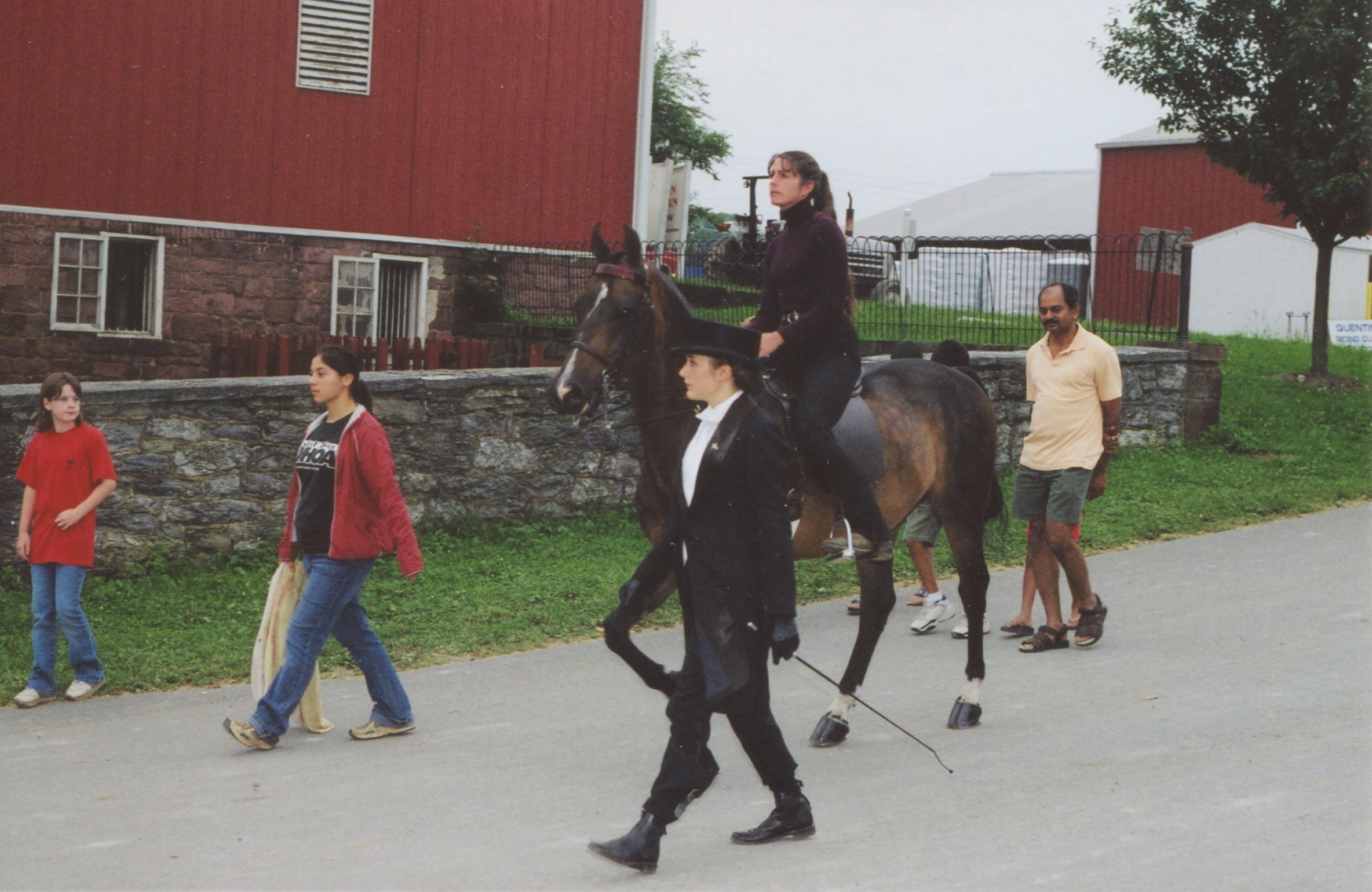 Allie Layos and Nicole DeGuzman with Brook Sweigart-Reed aboard Futurity's Gallant Son head down the hill to the Quentin warm-up ring. 