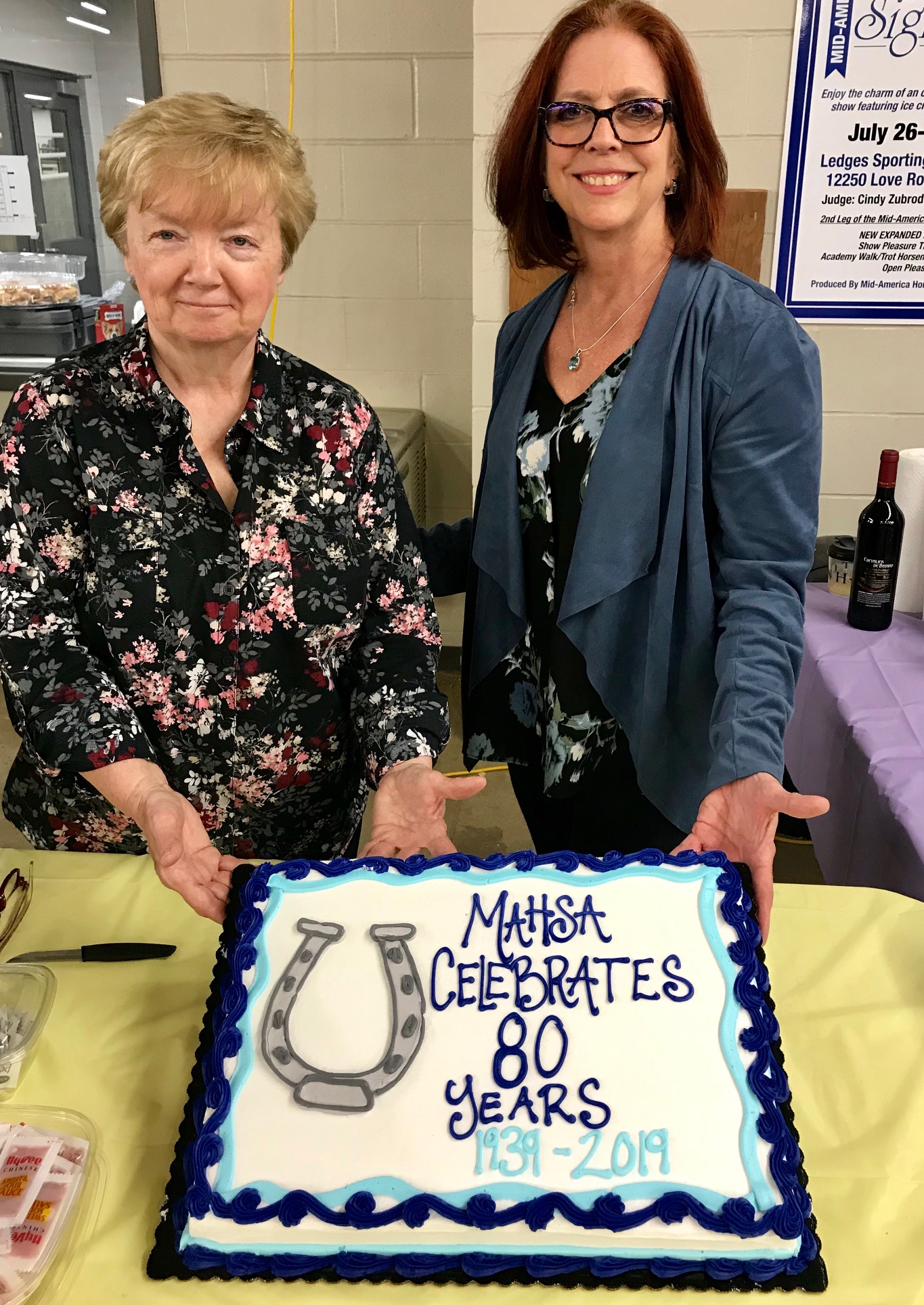 Marilou Wilschke, MAHSA Vice President, and Connie MacQueen, MAHSA President, present the MAHSA Celebrates 80 Years cake at the recent Spring Fling Horse Show, held at the Equestrian Center at Kirkwood.